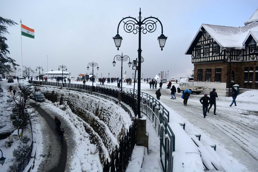 SHIMLA, INDIA - JANUARY 16:  People take a stroll during Shimla receiving second spell of snowfall at Ridge, on January 16, 2017 in Shimla, India. Shimla wrapped in white blankets of snow was a treat for tourists in Himachal Pradesh. The residents in the state capital here shivered as icy winds along with snow kept the minimum temperature at minus 0.3 degree Celsius. (Photo by Deepak Sansta/Hindustan Times via Getty Images)